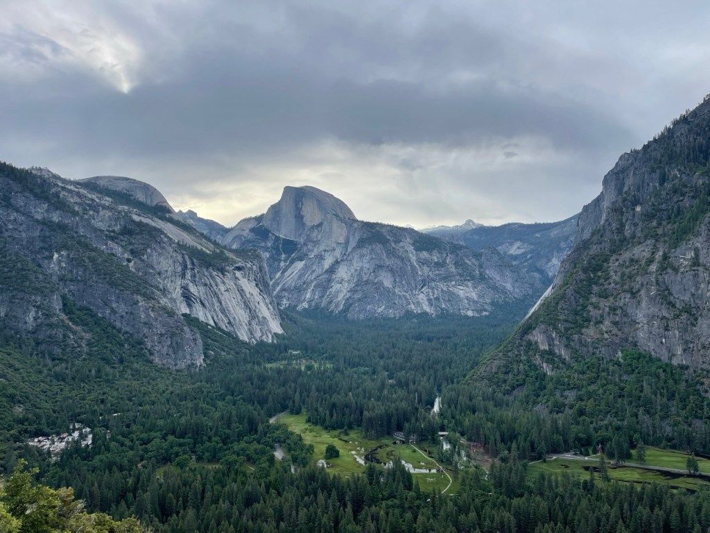 A forested valley between steep rock walls