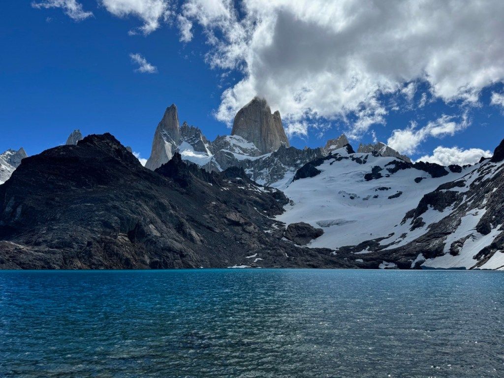 Jagged snowy peaks above a blue lake