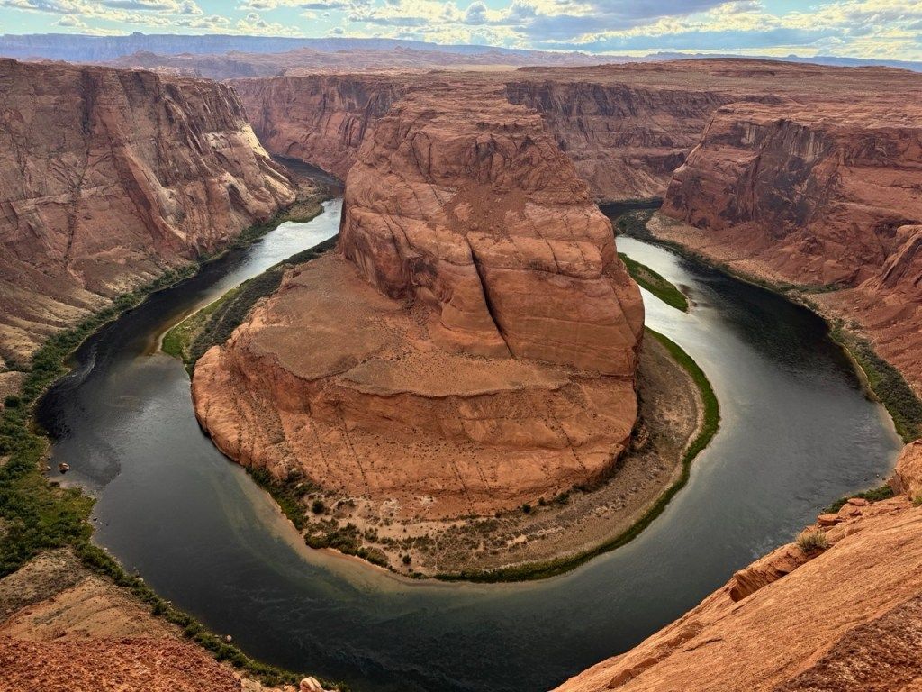 A river curving around a red rock canyon